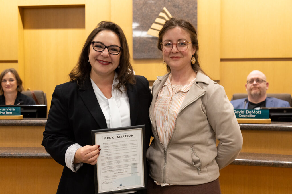 Owner of Ignite Counseling Colorado posing with photo of Small Business Week Proclamation and City Councillor Carmelia