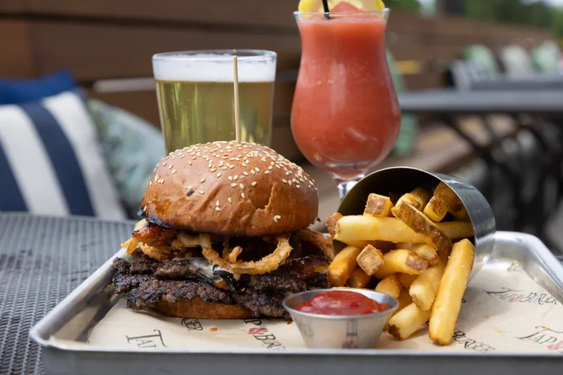 Hamburger, fries and drinks on a tray