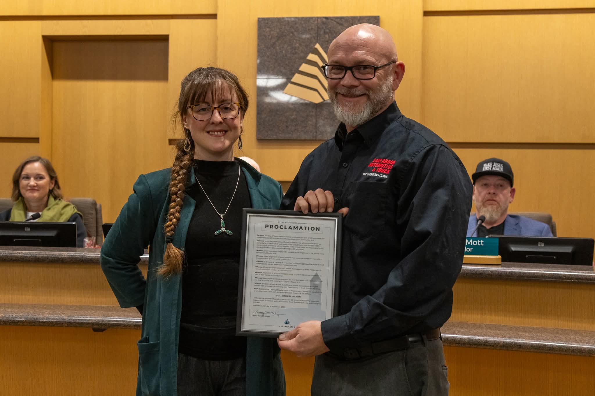 One person presenting a proclamation to another person accepting it